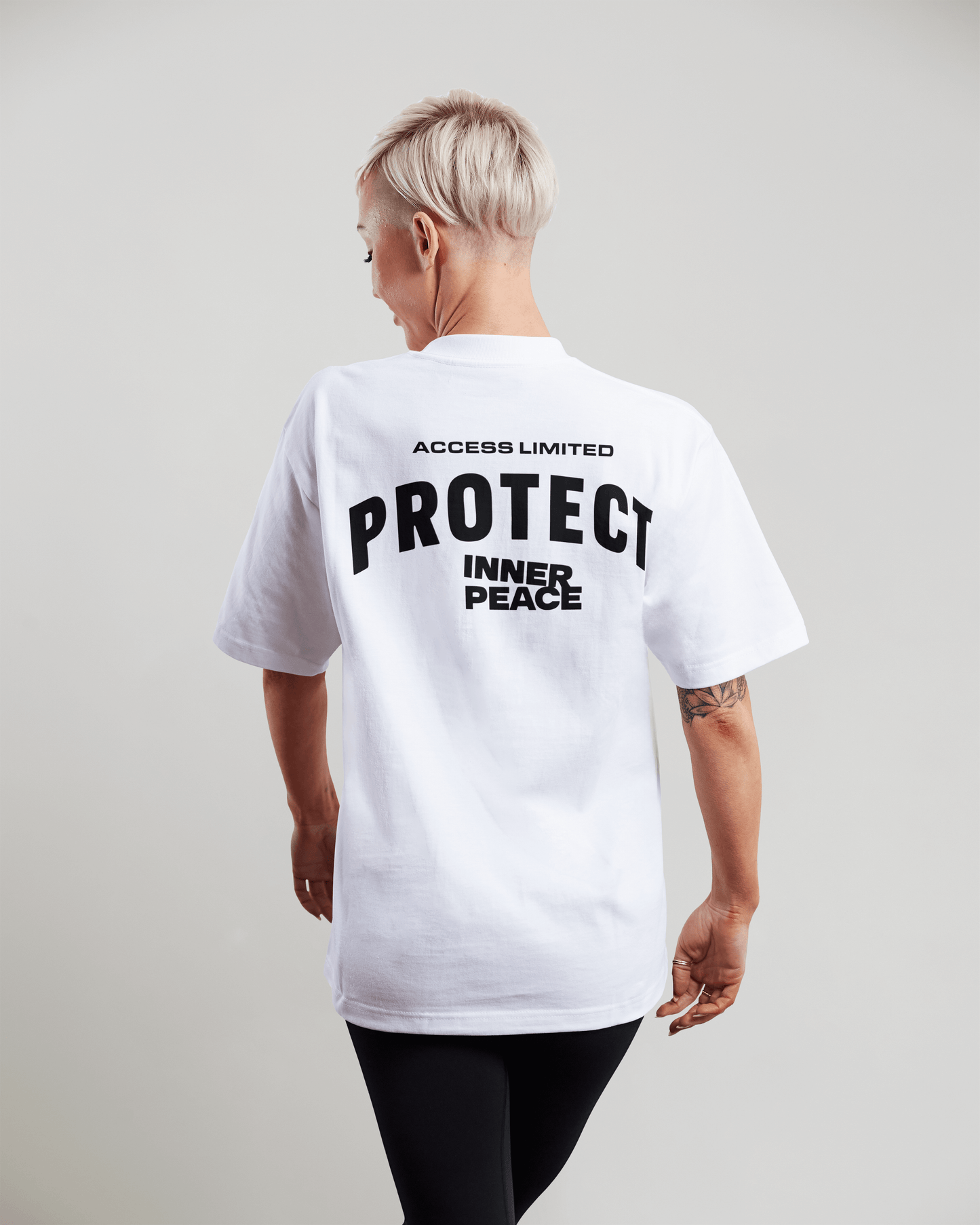 AXS+LMTD Made ME Irresistible Luxury T-shirt featuring bold 'PROTECT INNER PEACE' graphic on back.
