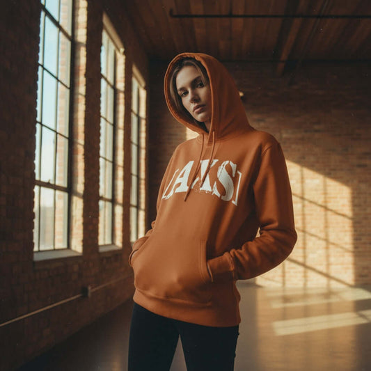 AXS+LMTD Autumn - Mid-weight Hoodie worn by a model in a stylish indoor setting, showcasing its bold logo design.