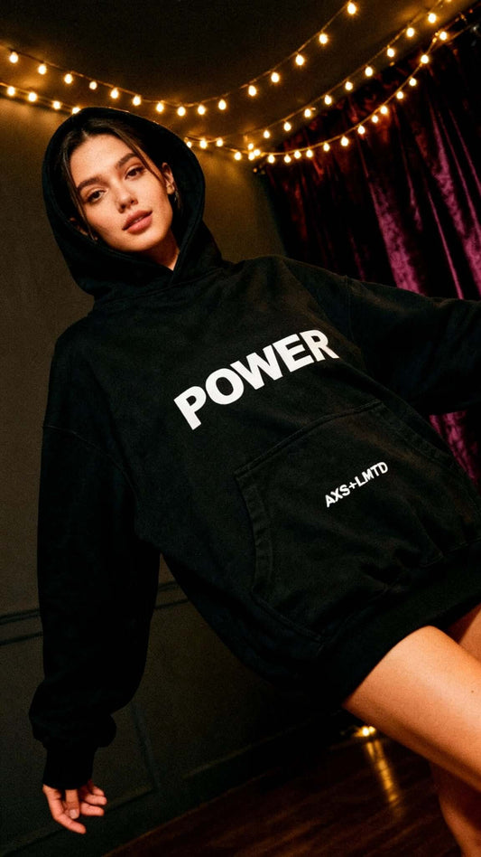 Model wearing a bold black hoodie with 'POWER' print, showcasing confidence and style, perfect for streetwear.