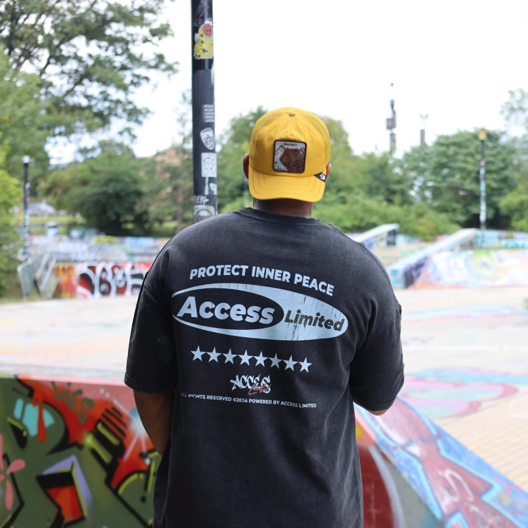 The Bite “Protect Inner Peace” Graphic Tee worn outdoors featuring bold slogan and Access Limited logo.