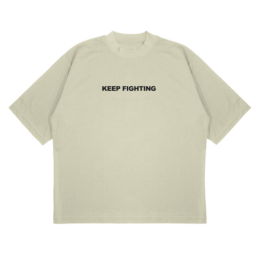 Beige t-shirt with 'KEEP FIGHTING' text on a white background